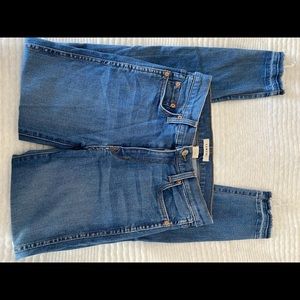 Comune skinny jeans with slits in at ankles.